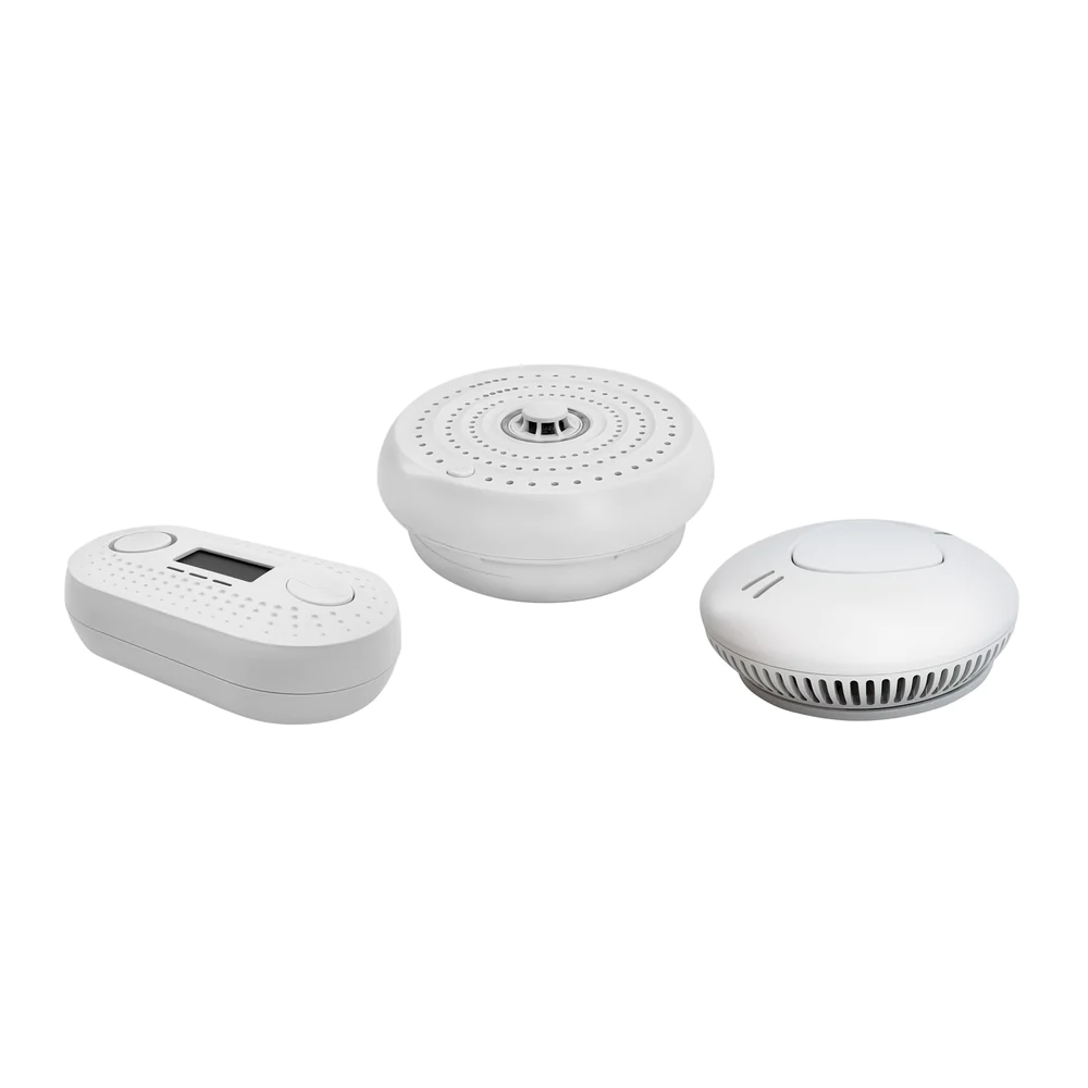 A couple of smoke alarms together on a white background